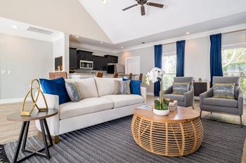 a living room filled with furniture and a large window
